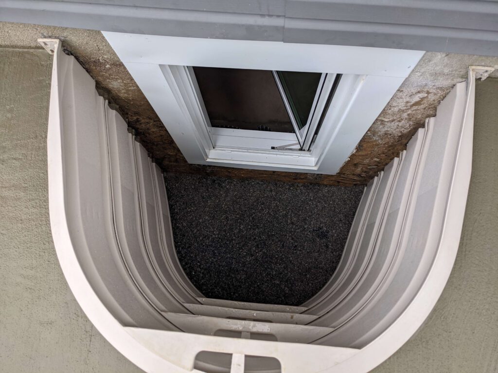Looking down into a basement egress window installed in Long Island
