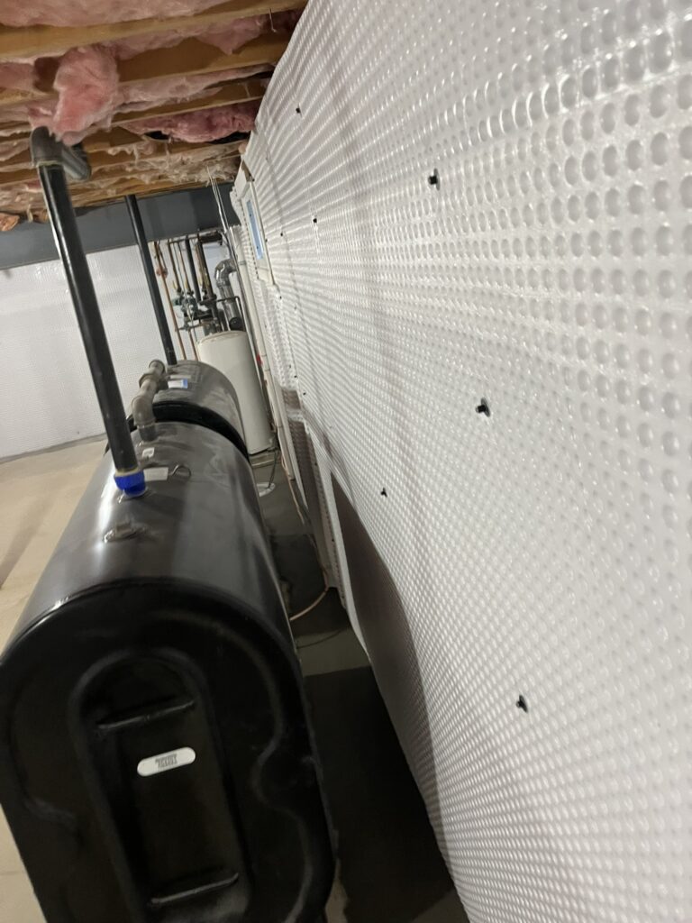 Protected basement wall waterproofing